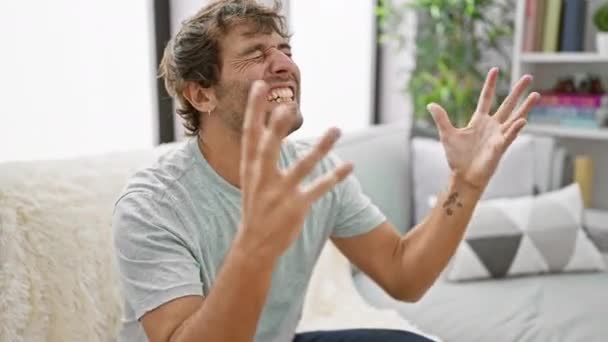 Aufgeregter Junger Mann Feiert Verrückten Verrückten Erfolg Auf Dem Sofa — Stockvideo