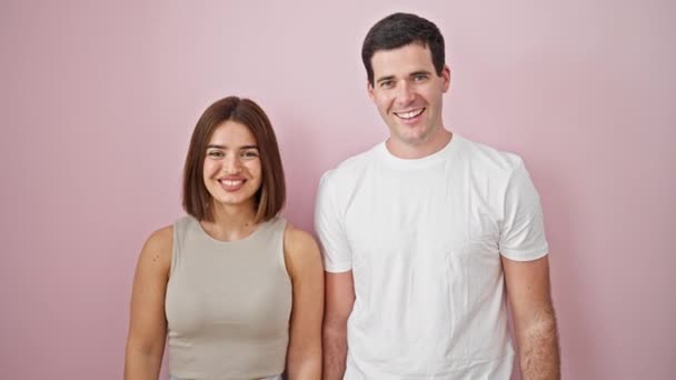Beautiful Couple Standing Together Bumping Fists Smiling Isolated Pink Background — Stock Video