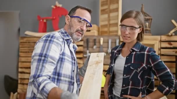 Two Dedicated Carpenters Speak Serious Shop Holding Lumber Plank Indoor — Stock Video