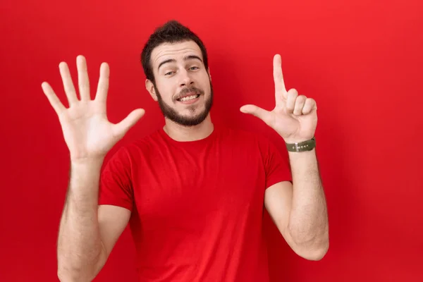 Young Hispanic Man Wearing Casual Red Shirt Showing Pointing Fingers — Stock Photo, Image