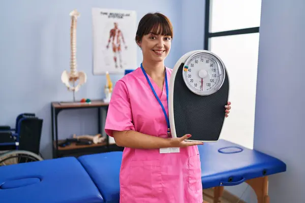 Young Brunette Woman Nutritionist Holding Weighing Machine Looking Positive Happy — Stock Photo, Image