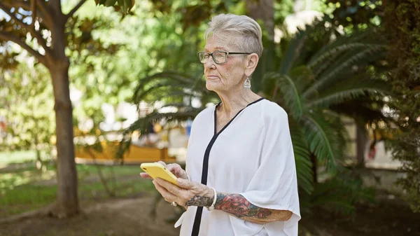 Cool Grey Haired Senior Woman Seriously Concentrates Texting Online Standing — Stock Photo, Image