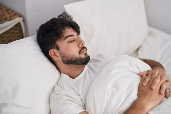 stock image Young hispanic man lying on bed sleeping at bedroom