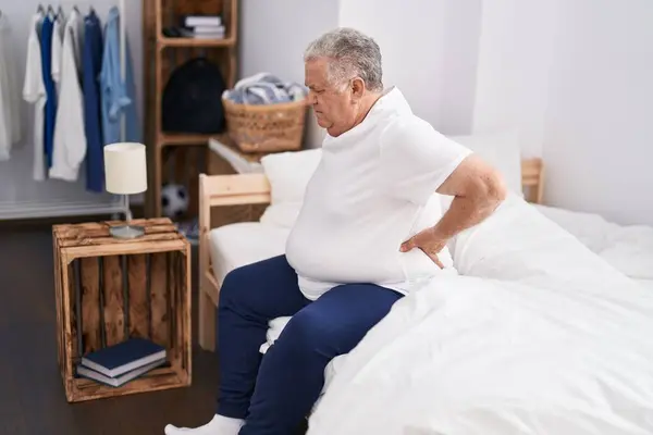 Middle Age Grey Haired Man Suffering Back Injury Sitting Bed — Stok fotoğraf