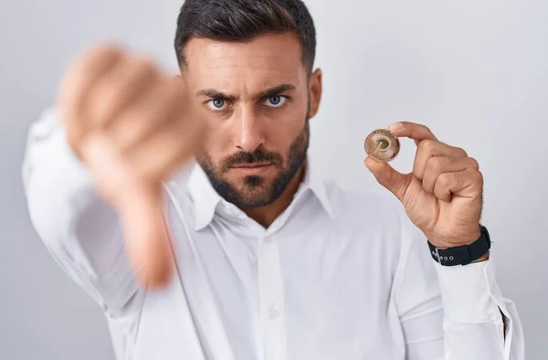 Handsome Hispanic Man Holding Polkadot Cryptocurrency Coin Angry Face Negative — Stock Photo, Image
