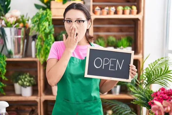 Hispanic Young Woman Working Florist Holding Open Sign Covering Mouth — Stock Photo, Image