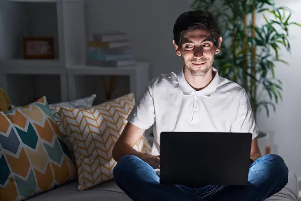 Young Hispanic Man Using Laptop Home Night Smiling Looking Side — Stock Photo, Image
