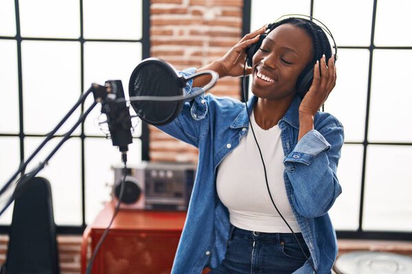 African american woman artist singing song at music studio