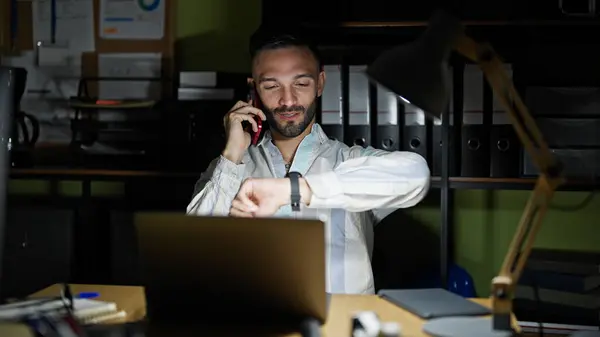 Young Hispanic Man Business Worker Talking Smartphone Looking Watch Office — Stock Photo, Image