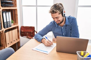 Young man call center agent smiling confident working at office