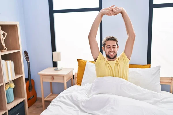 Young Man Waking Stretching Arms Bedroom — Stok fotoğraf