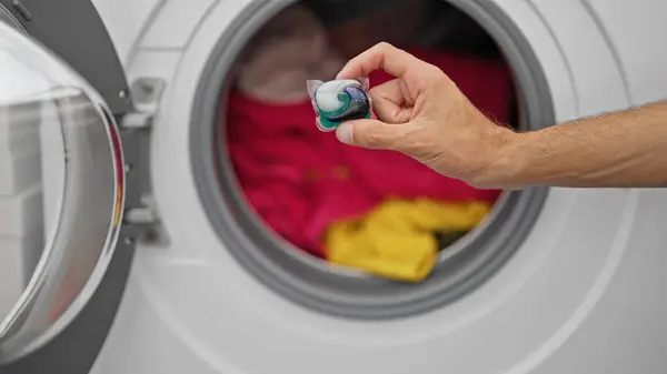 Young Hispanic Man Putting Detergent Bag Washing Machine Laundry Room — Stock Photo, Image