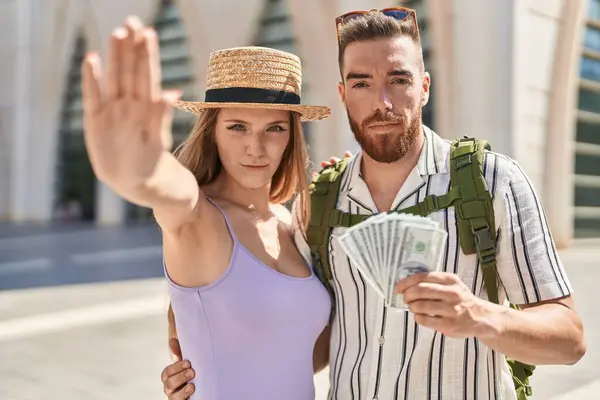 Young Tourist Couple Holding Dollars Banknotes Open Hand Doing Stop — Stock Photo, Image