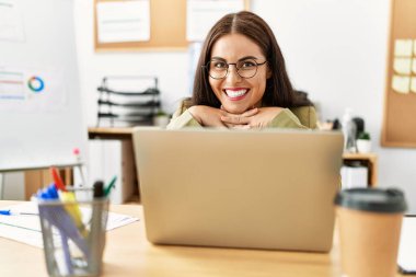 Young beautiful hispanic woman business worker using laptop working at office
