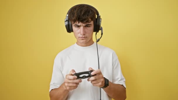 Upset Young Hispanic Teenager Engrossed Playing Video Game Stands Isolated — Stock Video