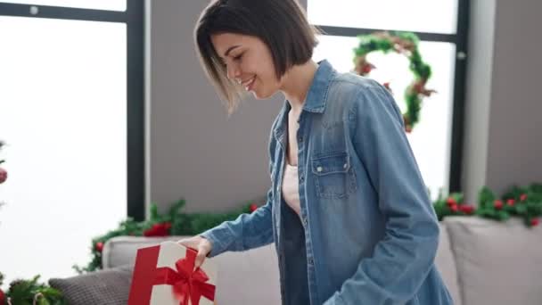 Young Caucasian Woman Putting Gift Christmas Tree Home — Stock Video