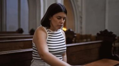 Viyana 'daki Augustinian Kilisesi' nde kilise bankında dua eden güzel İspanyol bir kadın.