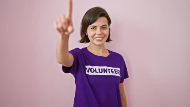 Glimlachende Jonge Vrijwilliger Mooie Spaanse Vrouw Die Speels Naar Wijst — Stockvideo