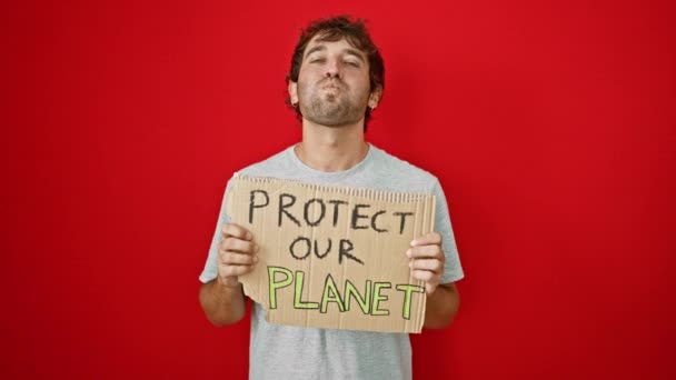 빨간색 배경에 우리의 지구를 보호배너를 들고있는 남자의 얼굴의 힐러리 — 비디오