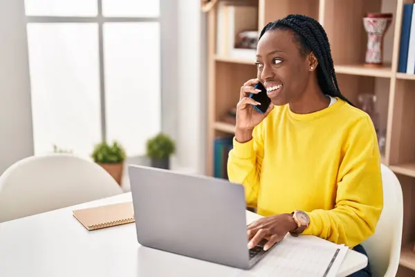 African American Woman Using Laptop Talking Smartphone Home — Stockfoto