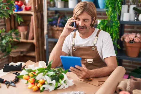Young Blond Man Florist Talking Smartphone Using Touchpad Flower Shop — Stock Photo, Image