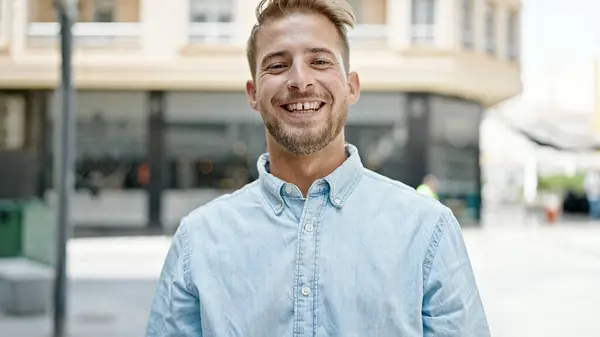 Young caucasian man smiling confident standing at street