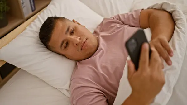 Young Latin Man Using Smartphone Lying Bed Bedroom — Stock Photo, Image