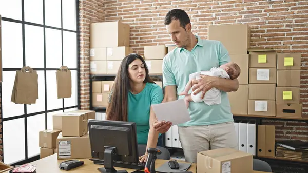 Family of three working at ecommerce business at office