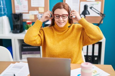 Young beautiful plus size woman call center agent smiling confident working at office