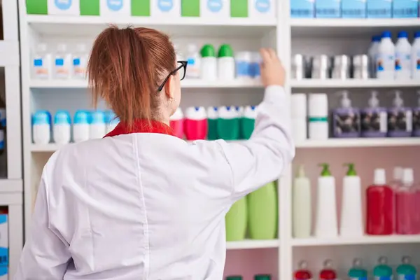 Young Beautiful Size Woman Pharmacist Holding Product Shelving Pharmacy — Stock Photo, Image