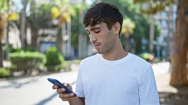Cool Looking Young Hispanic Man Serious Expression Deeply Engrossed Texting — Stock Photo, Image