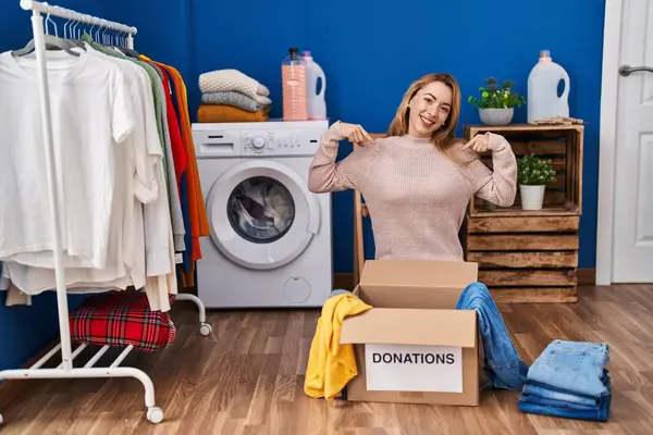 Hispanic Woman Putting Clothes Donation Box Looking Confident Smile Face — Stock Photo, Image