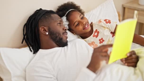 Afrika Amerika Ayah Dan Anak Membaca Buku Berbaring Tempat Tidur — Stok Video