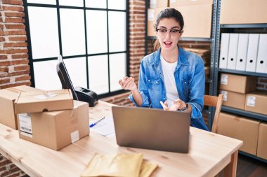 Young beautiful hispanic woman ecommerce business worker having video call at office