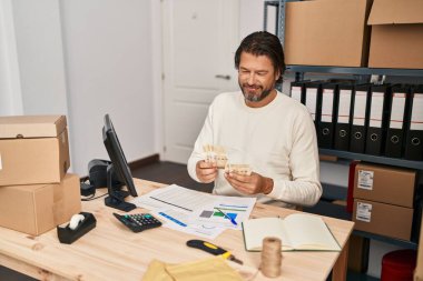 Middle age man ecommerce business worker counting denmark kroner banknotes at office
