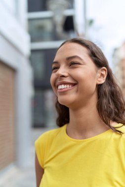 Young african american woman smiling confident looking to the side at street
