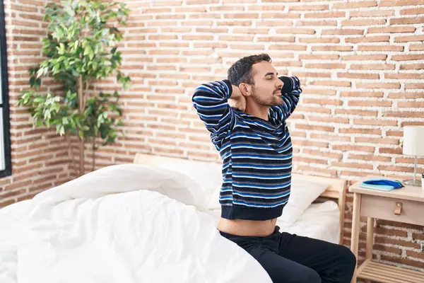 Young Hispanic Man Waking Stretching Arms Bedroom — Stock fotografie