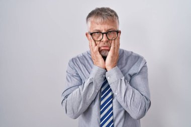 Gri saçlı, gözlüklü, yüzü, depresyonu ve üzüntüyü örten, üzgün ve sıkıntılı bir iş adamı. 