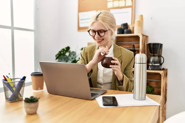 stock image Young blonde woman business worker using laptop drinking mate infusion at office