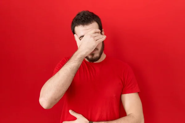 Young Hispanic Man Wearing Casual Red Shirt Covering Eyes Hand — Foto de Stock