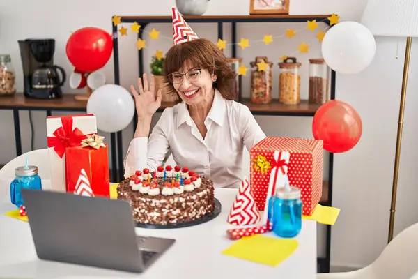 Middle age woman celebrating birthday having video call at home
