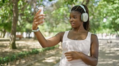 African american woman smiling confident having video call at park
