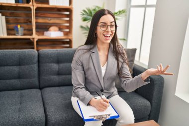 Genç ve güzel İspanyol kadın psikolog, psikoloji kliniğinde zihinsel seans düzenliyor.