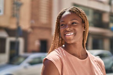 African american woman smiling confident looking to the side at street
