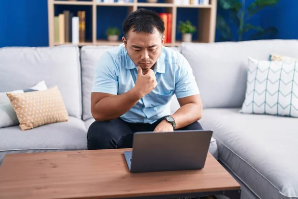 Young Chinese Man Using Laptop Serious Expression Home — Stock Photo, Image