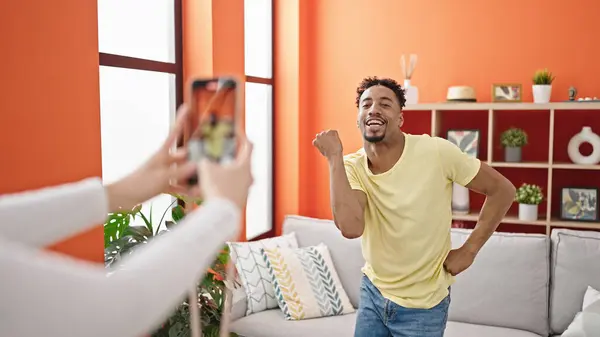 African american man recording video dancing at home