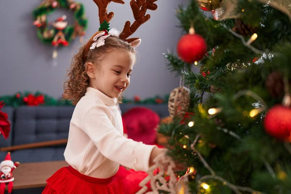 Adorable Blonde Girl Wearing Reindeer Ears Decorating Christmas Tree Home — Stock Photo, Image