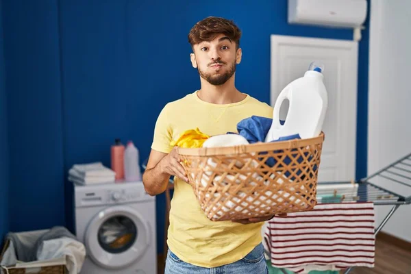 Arab Man Beard Holding Laundry Basket Detergent Bottle Puffing Cheeks — Stock Photo, Image