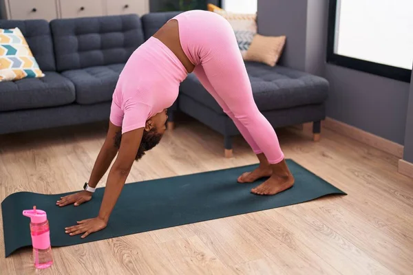 African american woman training yoga at home