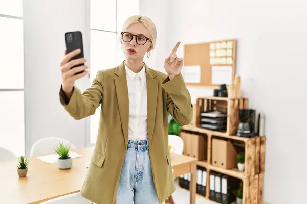Young blonde woman business worker having video call at office
